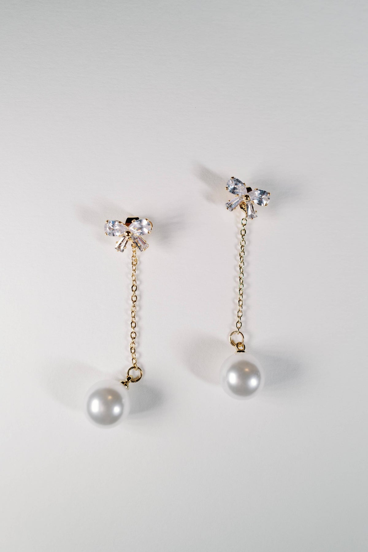 Crystal Bow and Pearl Drop Swingy Statement Earrings